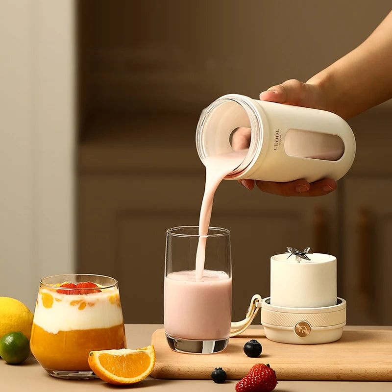 Person pouring a creamy liquid from a white container into a glass on a wooden surface with fruits.